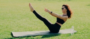 woman on yoga mat on grass