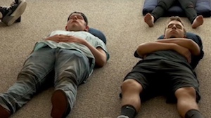 students lying on yoga mats